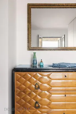 a dresser with a mirror on top of it at Cala & Cassari View By DomuSicily in Palermo