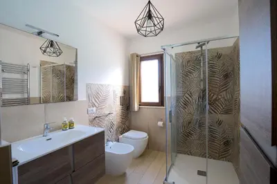 a bathroom with a shower and a toilet and a sink at Private Villa, Sun & Pool in Mandra Capreria