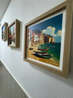 a painting of a beach with boats on a wall at Cappellieri centro apartament in Palermo