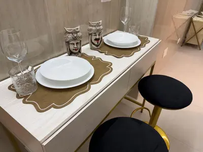 a table with plates and glasses and a chair at Cappellieri centro apartament in Palermo