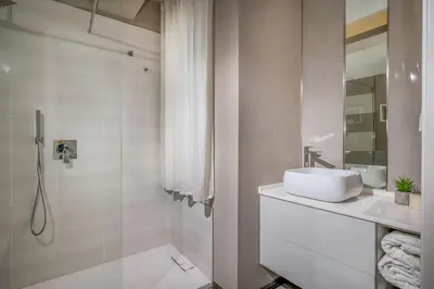 a white bathroom with a sink and a shower at Villa Sikelia con fantastica piscina in Alcamo