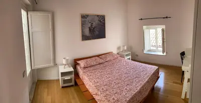 a bedroom with a bed and two night stands at Dai Pupi al 68 in Palermo