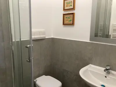 a bathroom with a sink and a toilet and a mirror at Dai Pupi al 68 in Palermo