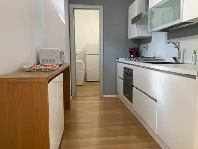a kitchen with white appliances and a wooden counter top at Dai Pupi al 68 in Palermo