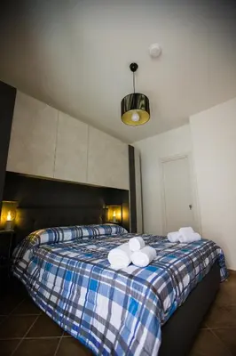 a bedroom with a bed with two towels on it at La Bucceria in Palermo