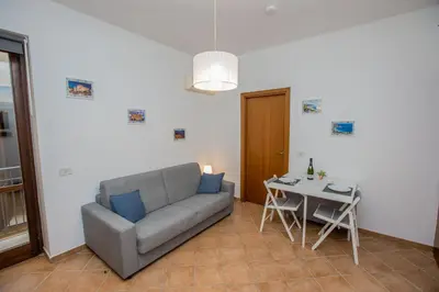 a living room with a couch and a table at La Bucceria in Palermo