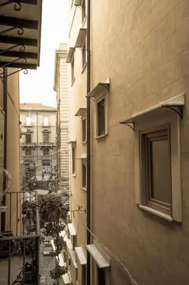 an alley with buildings and scaffolding in a city at La Bucceria in Palermo
