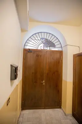 a wooden door in a room with a window at La Bucceria in Palermo