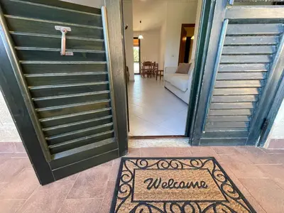an open door with a welcome mat in front of it at Sweet Summer House in Campofelice di Roccella