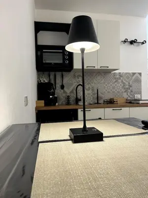 a lamp sitting on the floor in a kitchen at Palermo Home Cattedrale-Moderno Monolocale in Palermo