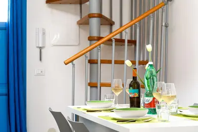 a table with glasses and wine bottles on it at Panarea SVLC in San Vito lo Capo