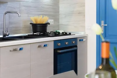 a kitchen with a sink and a stove with a pot on it at Panarea SVLC in San Vito lo Capo