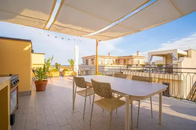a patio with a table and chairs on a balcony at Solemar Sicilia - Casa Alba in Santa Flavia