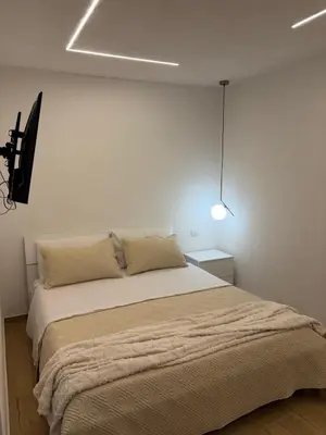 a bedroom with a large bed in a white room at A casa del capo in Palermo