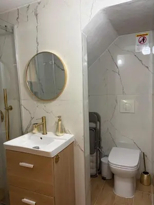 a bathroom with a sink and a toilet and a mirror at A casa del capo in Palermo