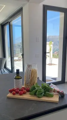 a cutting board with tomatoes and vegetables on a counter at Villa Muntaja in Scopello