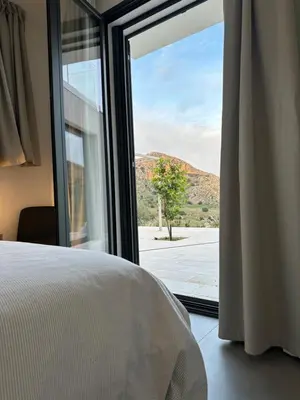 a bedroom with a window with a view of a mountain at Villa Muntaja in Scopello