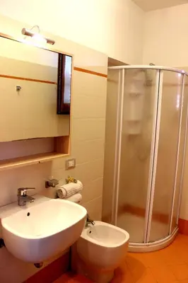 a bathroom with a white sink and a shower at Appartamento Calvino piano terra in via Mulino 31 in San Vito lo Capo