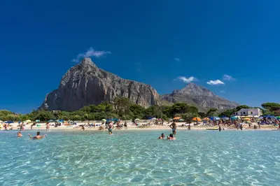 a group of people in the water on a beach at Appartamento Calvino piano terra in via Mulino 31 in San Vito lo Capo