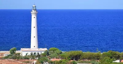 a lighthouse on a hill next to the ocean at Appartamento Calvino piano terra in via Mulino 31 in San Vito lo Capo