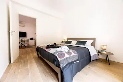 a bedroom with a large bed and a desk at A due passi dal mare in Palermo
