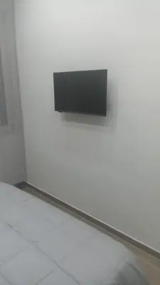 a white wall with a black object on it at Casa Bruno in Palermo
