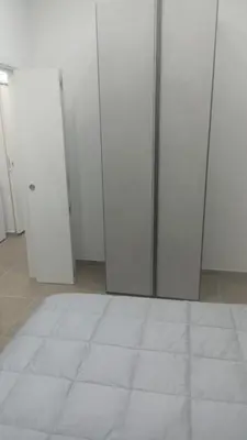 a room with white doors and a white tile floor at Casa Bruno in Palermo