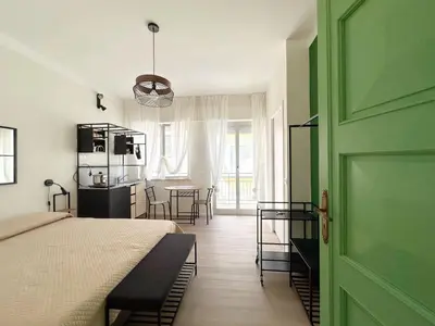 a bedroom with a bed and a green door at Cielo D'Alcamo Palazzo Antichi Quartieri in Alcamo