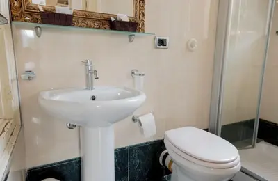 a bathroom with a sink and a toilet at Cielo D'Alcamo Palazzo Antichi Quartieri in Alcamo