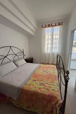 a bedroom with a bed in a room with a window at Apartment für 6 oder 7 Personen by Interhome in Balestrate