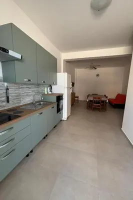 a kitchen with blue cabinets and a table in a room at Apartment für 6 oder 7 Personen by Interhome in Balestrate