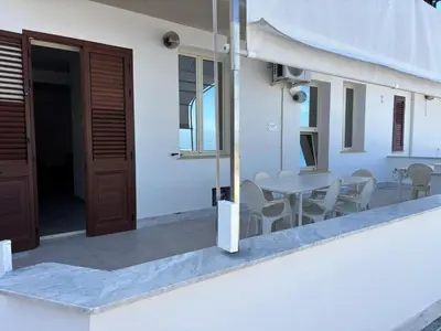 a balcony with a table and chairs and a door at Apartment für 6 oder 7 Personen by Interhome in Balestrate