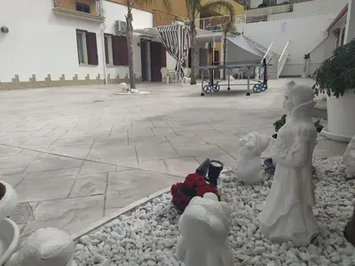 a group of statues sitting on rocks in a yard at Apartment Wohnung 8 by Interhome in Balestrate