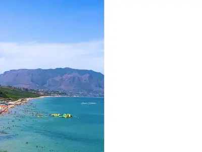 a view of a beach with mountains in the background at Apartment Wohnung 8 by Interhome in Balestrate