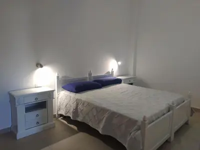 a bedroom with a white bed and two night stands at Apartment Ferienhäuser Small App- für 5 in Balestrate by Interhome in Balestrate