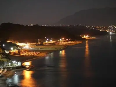 a view of a river at night with lights at Apartment Wohnung in Balestrate mit Schwimmbad und Meerblick by Interhome in Balestrate