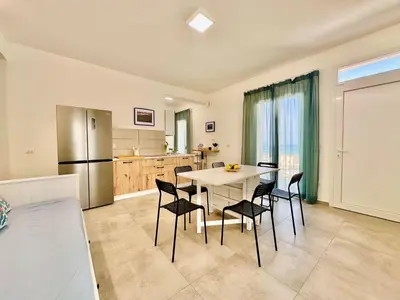 a kitchen and dining room with a table and chairs at Apartment Sea Life Giulia- 200 m vom Strand entfernt by Interhome in Alcamo Marina