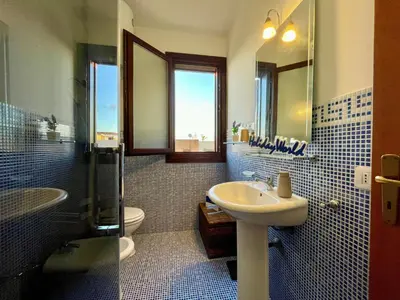 a bathroom with a sink and a toilet and a mirror at Apartment Casa Sterlizia bei Holiday World by Interhome in San Vito lo Capo