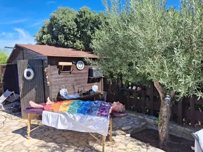 a person laying on a bed next to a dog house at Holiday Home Entspannung- Meer- Natur- Kultur by Interhome in Partinico