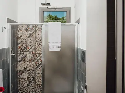 a bathroom with a shower with a towel at Holiday Home Haus in Balestrate mit privatem Parkplatz by Interhome in Balestrate
