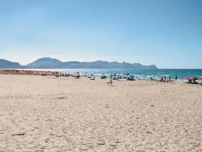 a group of people walking on a beach at Apartment Wohnung maestrale Sizilien home by Interhome in Balestrate