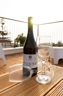 a bottle of wine and a glass on a table at Holiday Home Villa Panorama del Golfo mit privatem Pool und Grillplatz by Interhome in Balestrate