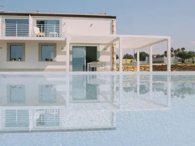 a villa with a swimming pool in front of a house at Holiday Home in Partinico mit Privatem Pool by Interhome in Balestrate