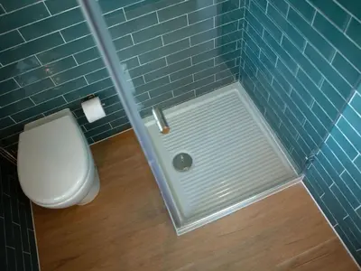 a bathroom with a toilet and a blue tiled wall at Holiday Home in Partinico mit Privatem Pool by Interhome in Balestrate
