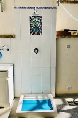 a bath tub in a bathroom with a tile wall at Holiday Home Villa Oasi- 50 m vom Strand entfernt- klimatisiert by Interhome in Alcamo