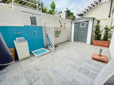 a garage with a gate and a door in a yard at Holiday Home Villa Oasi- 50 m vom Strand entfernt- klimatisiert by Interhome in Alcamo