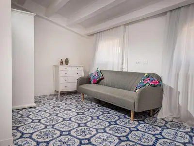 a living room with a couch on a tile floor at Apartment BluOltremare-Terrasse by Interhome in Castellammare del Golfo