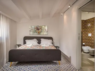 a bedroom with a bed and a bathroom at Apartment BluOltremare-Terrasse by Interhome in Castellammare del Golfo