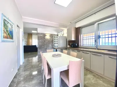 a kitchen with a white table and chairs at Holiday Home Villa Grace- Strand 200 m entfernt by Interhome in Alcamo