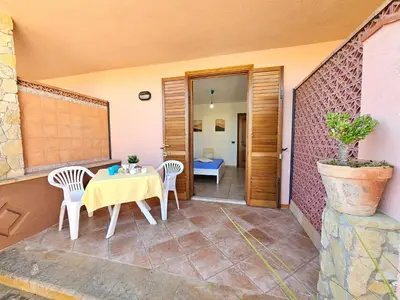 a small patio with a table and two chairs at Holiday Home Villa mit Wasserblick by Interhome in Campofelice di Roccella